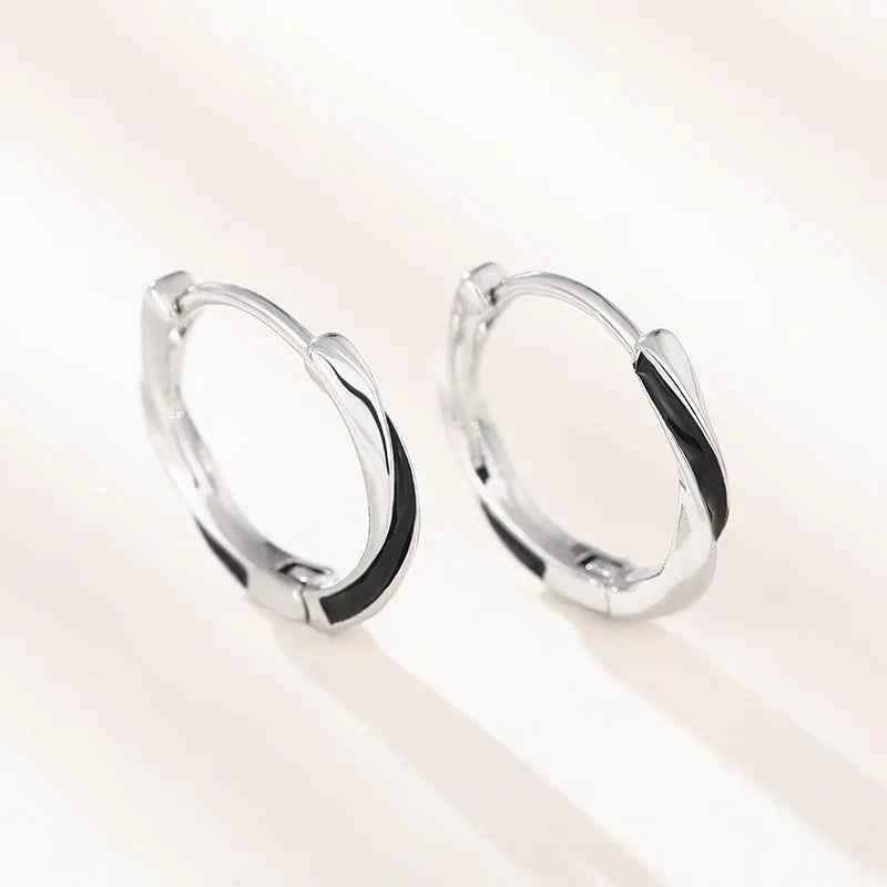 Silver hoop earrings - geometric rhodium plated design in white gold color on model