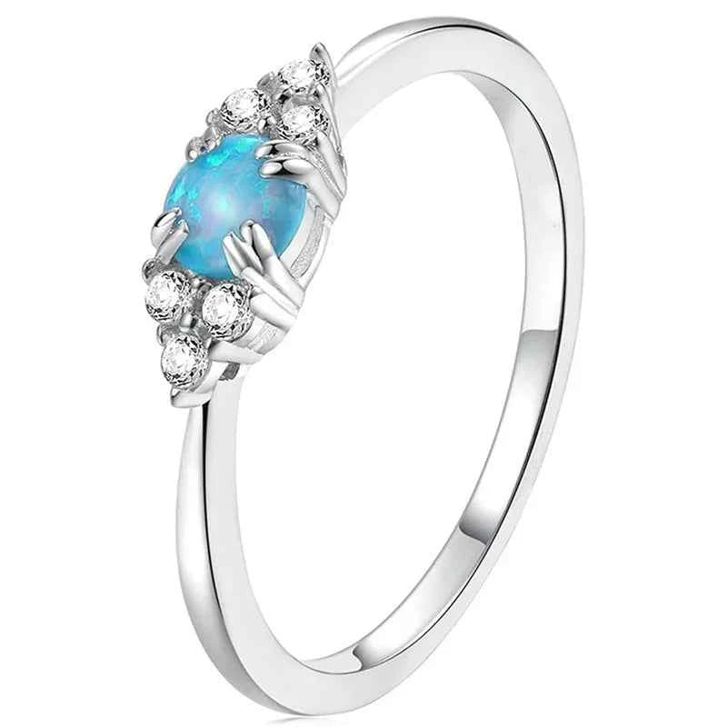 Silver engagement ring with natural round brilliant diamond center and side diamonds on polished silver band