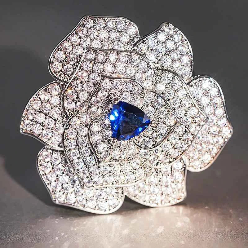 Sapphire flower brooch - 925 silver with pave setting and blue sapphire center