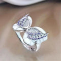 Hip hop CZ ring - religious gemstone claw inlay with brass plating on a clean background