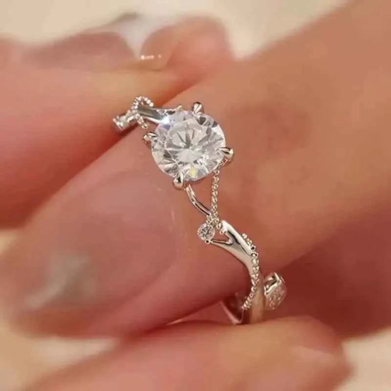 Natural diamond engagement ring - round brilliant cut in white gold with G color side stones