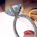 Triangular diamond ring - triangular center stone with halo pavé set in fully paved band