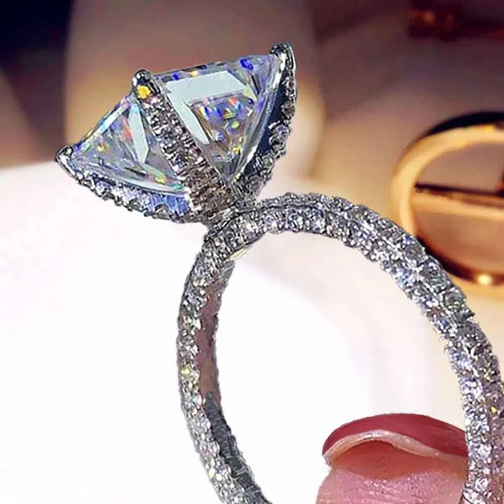 Triangular diamond ring - triangular center stone with halo pavé set in fully paved band