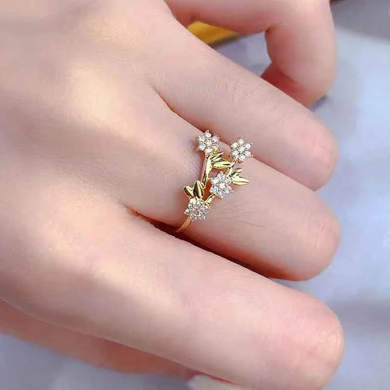 Cubic zirconia flower ring - gold-tone pave setting with round stone, elegant floral design