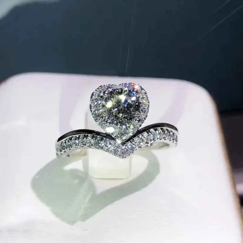 Heart cut engagement ring - natural D color diamond in white gold with halo setting and pave band