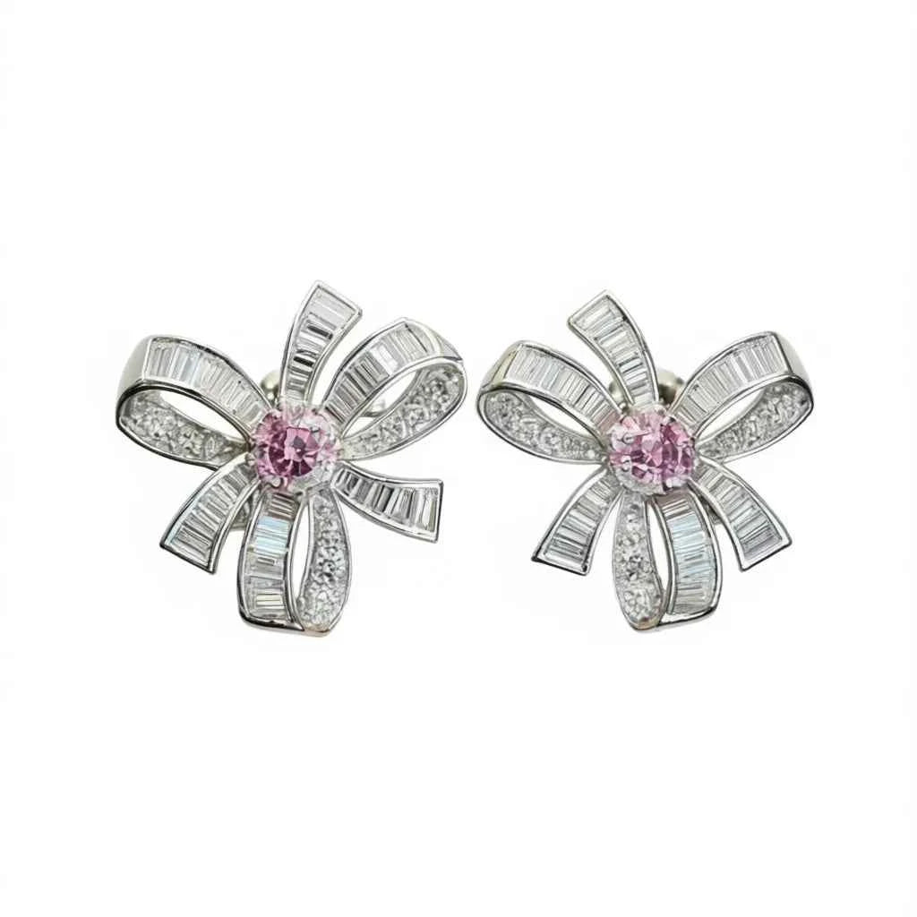 Fancy pink diamond earrings - white gold baguette cut with pink center diamond on display