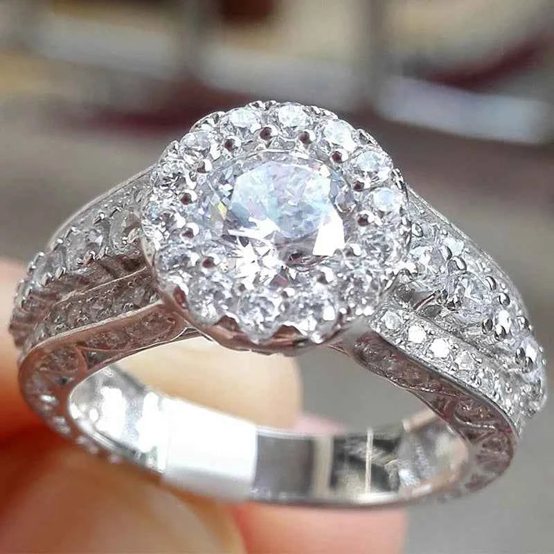 Elegant diamond halo ring - oval cut center stone with pavé band on white background