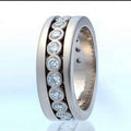 White gold eternity band - round brilliant diamond channel setting ring on white background