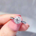 Halo diamond engagement ring - round brilliant cut white gold with pavé set diamonds on band