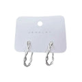 White gold hoop earrings - classic twisted hoop with polished finish on white background