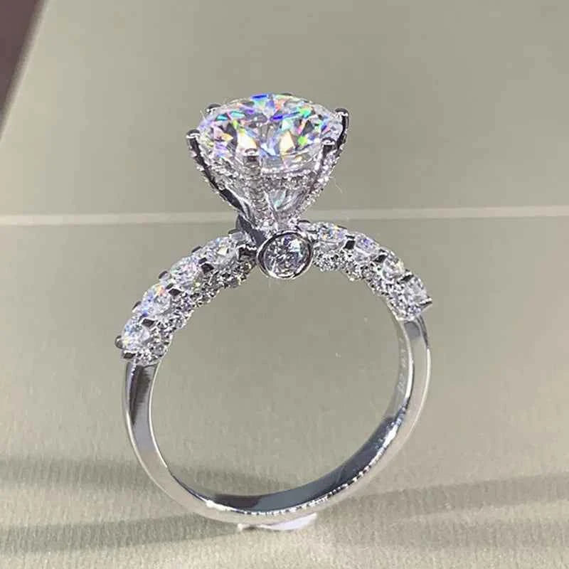 Natural diamond engagement ring - white gold round brilliant cut with halo and pavé band