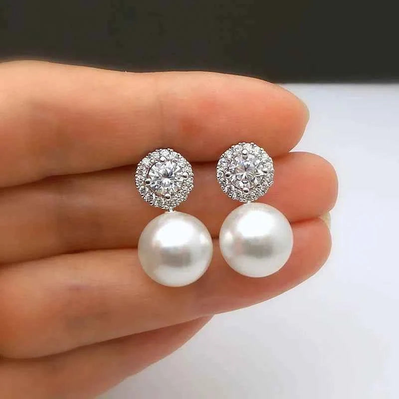 White gold pearl stud earrings – round brilliant cut diamond imitation halo on white background