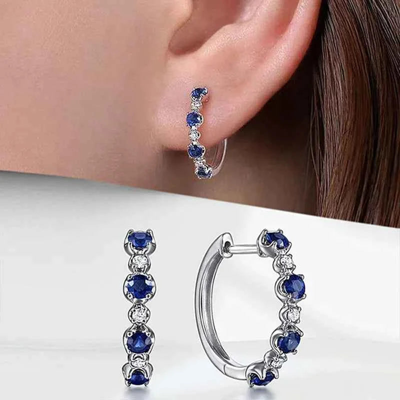 White gold hoop earrings with brilliant-cut zircon - classic style for women with claw setting on white background
