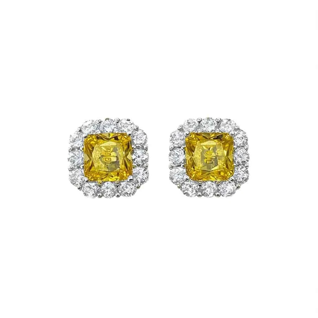 Yellow diamond stud earrings - cushion cut bezel set geometric design on display