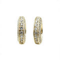 Crystal hoop earrings - gold-plated channel set with sparkling rhinestones on a dark background