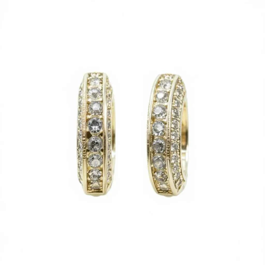 Crystal hoop earrings - gold-plated channel set with sparkling rhinestones on a dark background
