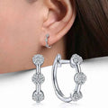 White gold hoop earrings - crystal rhinestones in snowflake pattern on rhodium plated silver
