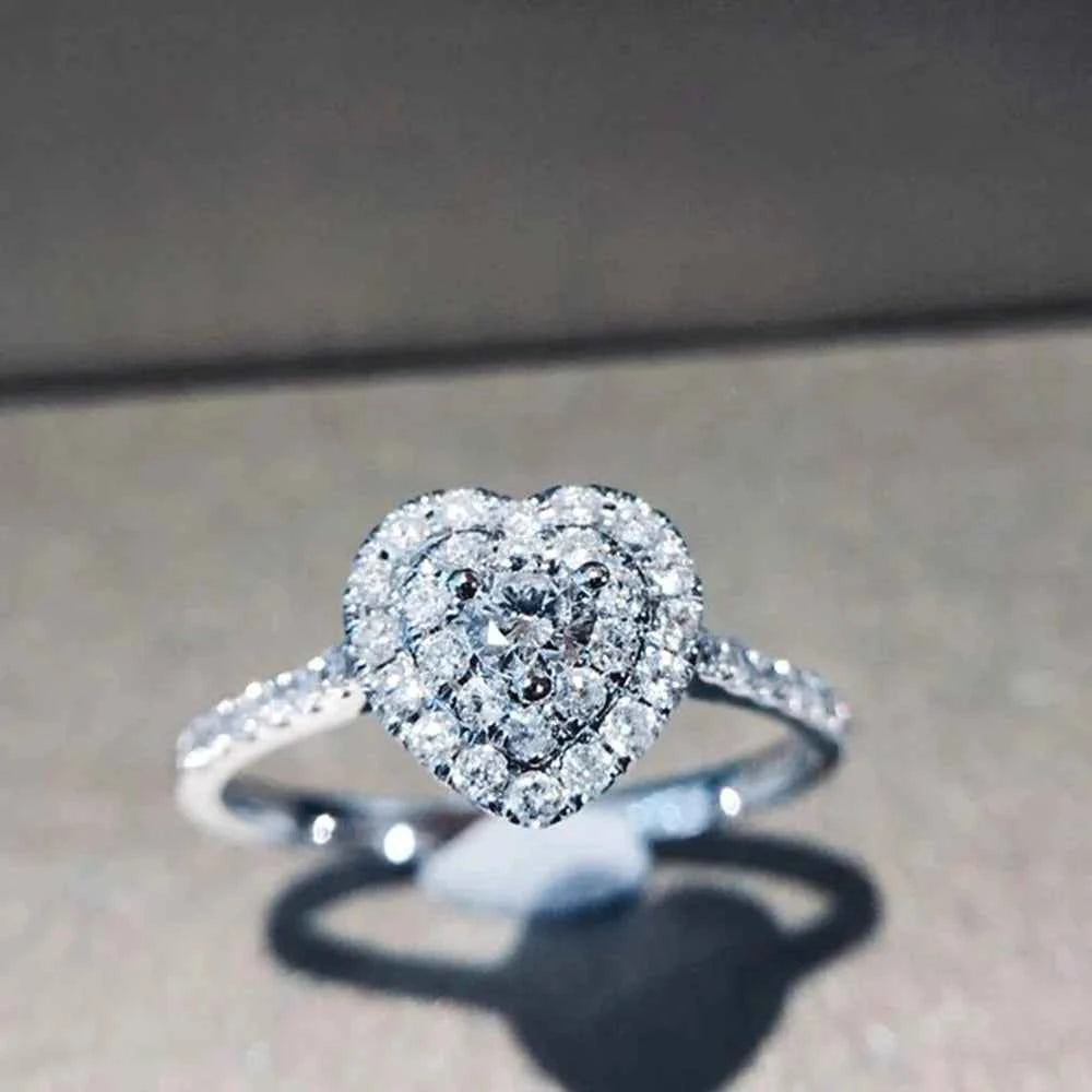 Heart cut diamond ring - elegant white gold engagement ring with G color diamond center and side stones