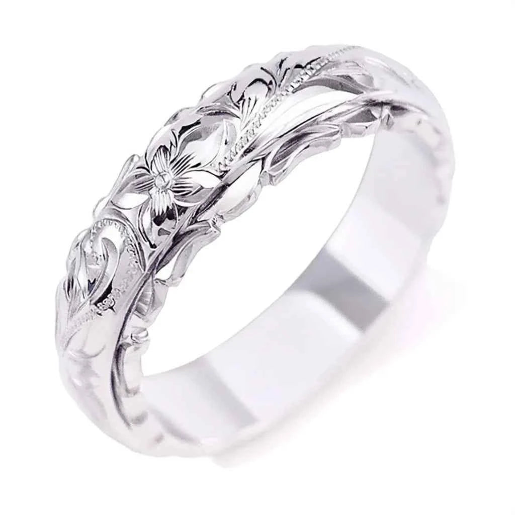 White gold wedding band with round brilliant cut diamond and floral carving on copper base