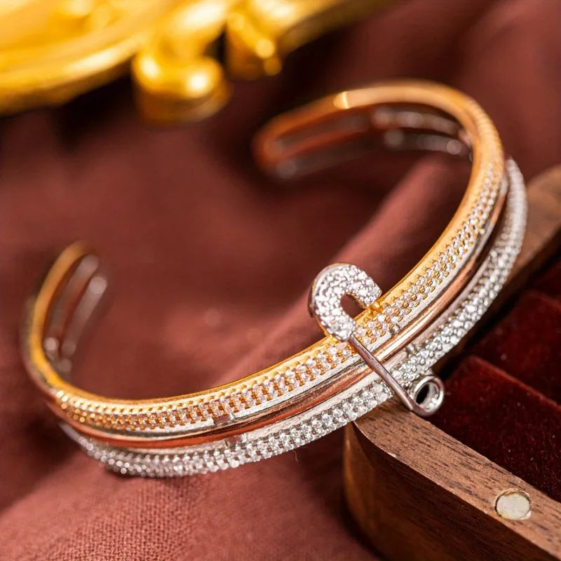 Elegant copper bangle bracelet - unique safety pin design on a woman's wrist