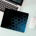Gaming Mouse Pad - black hexagonal honeycomb design on a desk