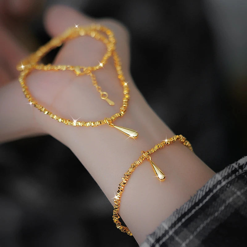 Gold water droplet jewelry set - elegant necklace and bracelet with shiny gold color finish